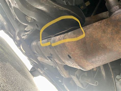 metal sheet above exhaust loose|metal plate above exhaust pipe.